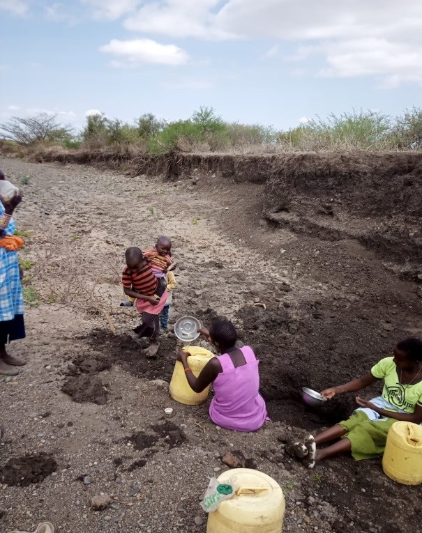 Samburu women and children scavenging for water